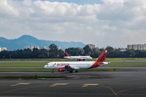 An Airbus A320 from Avianca is taxiing on the runway.