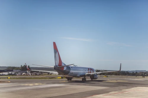 A Boeing 737 is taxiing on the apron.