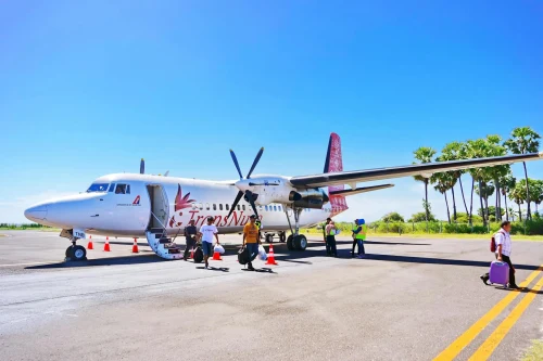 Benin Airlines (9B) aircraft on the apron under clear skies.