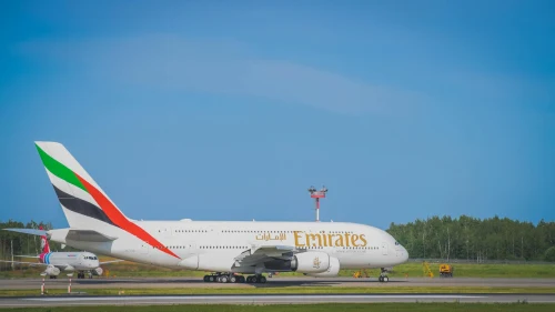 Emirates (EK) aircraft on the apron.
