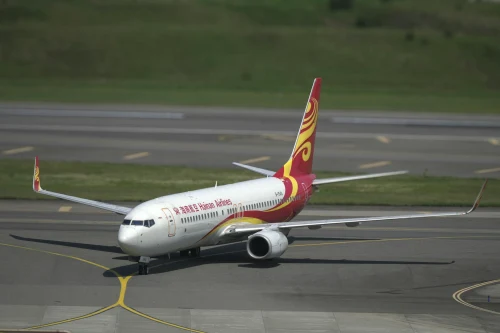Hainan Airlines Boeing 737 (HU) taxiing on the airport apron.