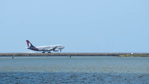 A Hawaiian Airlines Airbus A321neo is seen taxiing along the runway.