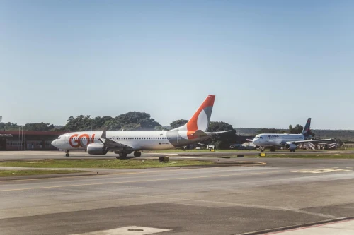 A Boeing 737 from Kolula Com is seen on the apron alongside another aircraft.