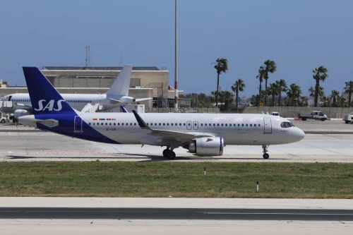 A SAS Airbus A320 is taxiing on the airport apron.