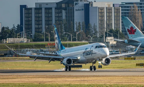 A Skywest Embraer E175 is taxiing on the apron.
