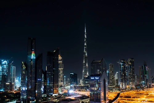 Stunning nighttime view of Dubai's skyline with the iconic Burj Khalifa illuminated under a starry sky