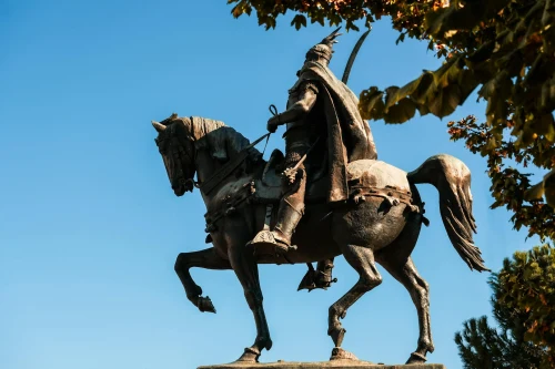 Majestic statue of national hero Skanderbeg on horseback under a clear blue sky in Tirana