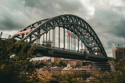 View of the historic Tyne Bridge in Newcastle upon Tyne, England amidst a cloudy sky