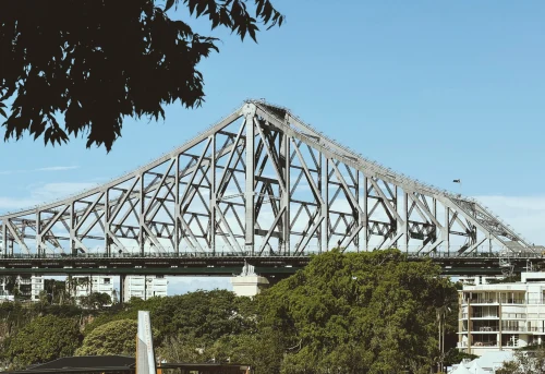 Iconic Story Bridge in Brisbane under a clear blue sky with lush greenery