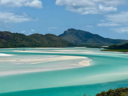 Beautiful turquoise waters and white sands of Whitsundays, Australia under a clear blue sky