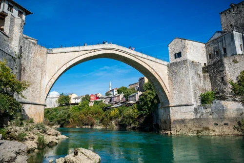 View of the historic Stari Most bridge in Mostar, Bosnia, under a clear blue sky