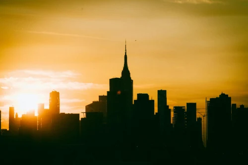 Silhouette of New York City skyline with Empire State Building at sunset