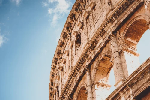 Detailed view of the Colosseum in Rome, Italy with a vibrant blue sky