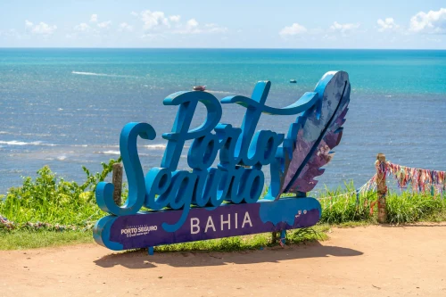 Vibrant Porto Seguro Bahia sign under a sunny blue sky with ocean view