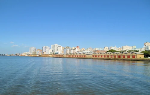 Panoramic view of Porto Alegre's skyline along the waterfront under a clear blue sky