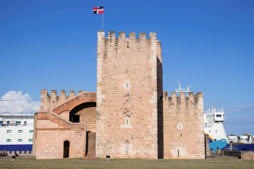Old stone fortification, Fortaleza Ozama, under clear blue sky in Santo Domingo, Dominican Republic