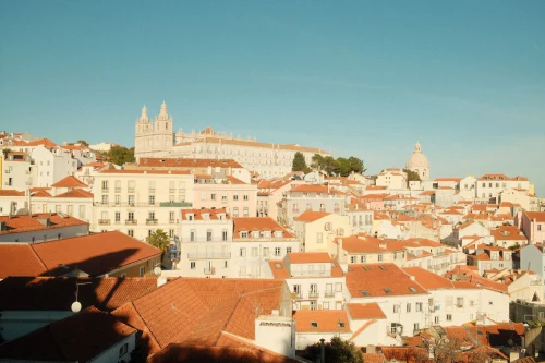 Beautiful sunny panorama of Lisbon's historic rooftops with iconic architecture and landmarks