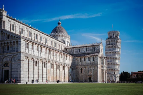 Iconic view of the Leaning Tower and Pisa Cathedral in Tuscany, Italy, on a clear sunny day