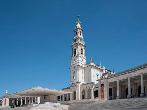 The Sanctuary of Fátima tower in Portugal against a clear blue sky, capturing its architectural beauty