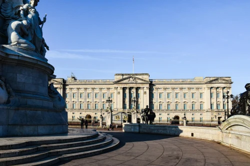 Stunning view of Buckingham Palace with clear blue skies and iconic statues in London, England