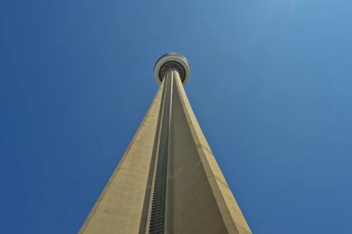 Vertical view of the iconic CN Tower soaring against a clear blue sky in Toronto, Canada