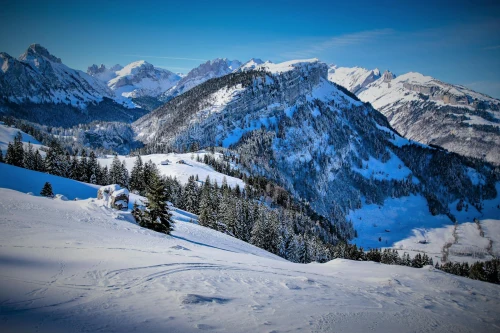 Majestic snowy mountains of Schwende-Rüte in Switzerland under a bright blue sky