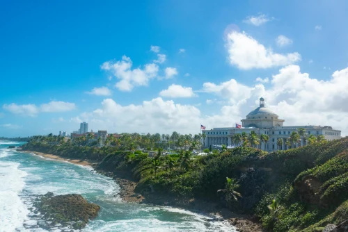Stunning view of San Juan's coast with the iconic Capitol building against a bright blue sky