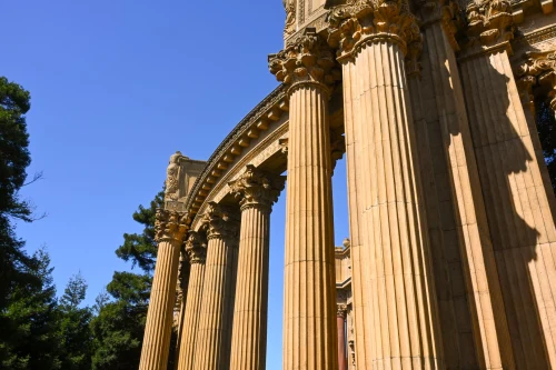 Elegant classical columns of the Palace of Fine Arts in San Francisco against a clear blue sky
