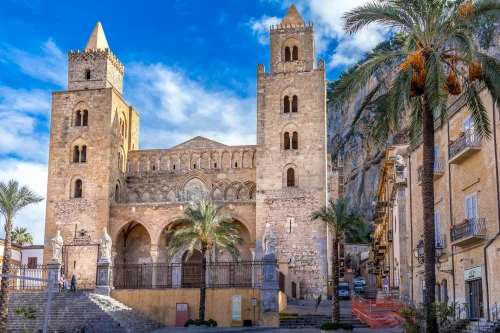 Stunning view of the historic Cefalù Cathedral in Sicily, Italy, under a bright blue sky