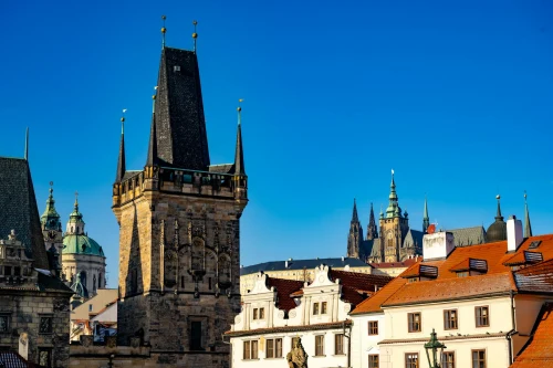 Capture of Prague's historic skyline featuring St. Vitus Cathedral and medieval towers under a clear blue sky