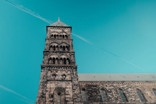 Impressive view of Lund Cathedral's tower under a clear blue sky