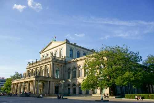 Historic Hannover Opera House with classical architecture in sunny weather, featuring urban surroundings