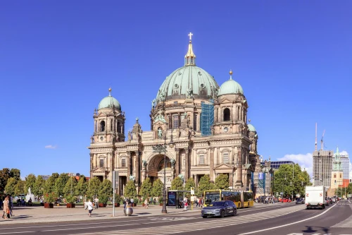 A stunning view of Berlin Cathedral captured on a sunny day, showcasing its architectural grandeur and bustling surroundings