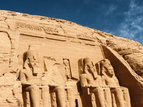The iconic rock-hewn statues at Abu Simbel under a clear blue sky, Egypt's ancient marvel