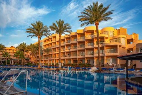 Elegant hotel with palm trees and poolside in Hurghada, Egypt during a sunny day