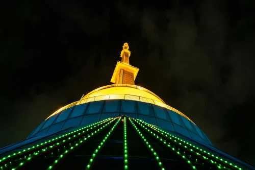 Dramatic night shot of the iconic Lotus Tower in Colombo, Sri Lanka, showcasing its vibrant lights
