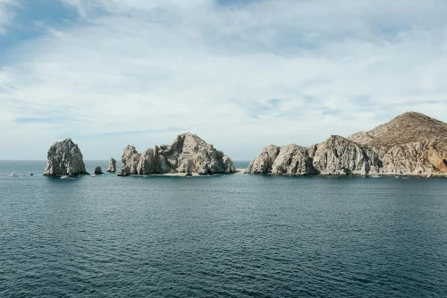 Stunning seascape of Cabo San Lucas with iconic rock formations under a clear blue sky