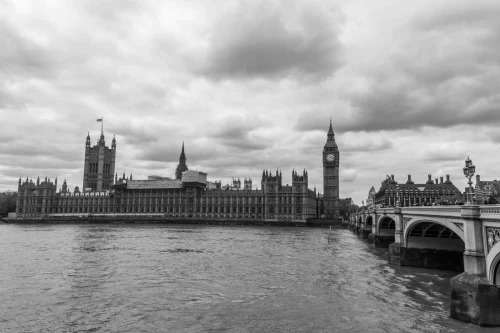 Classic black and white photo capturing Big Ben and the Palace of Westminster from the River Thames