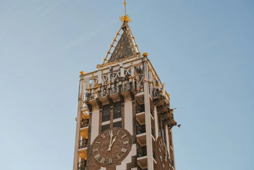 A stunning view of the iconic Batumi Clock Tower in Georgia against a clear blue sky