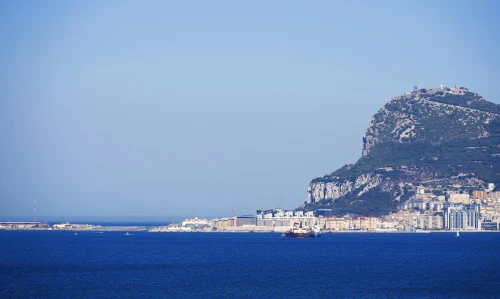 Scenic view of the iconic Rock of Gibraltar, with clear blue sky and sea, ideal for travel imagery