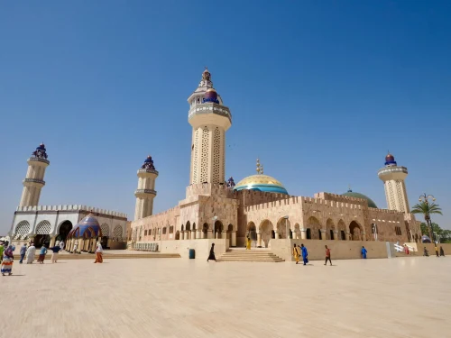 The Grand Mosque of Touba, Senegal, with its iconic minarets under a clear blue sky, showcasing Islamic architecture