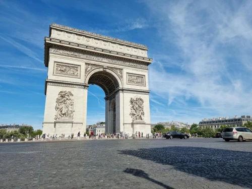 Explore the iconic Arc de Triomphe in Paris with this vivid daytime capture under a clear blue sky