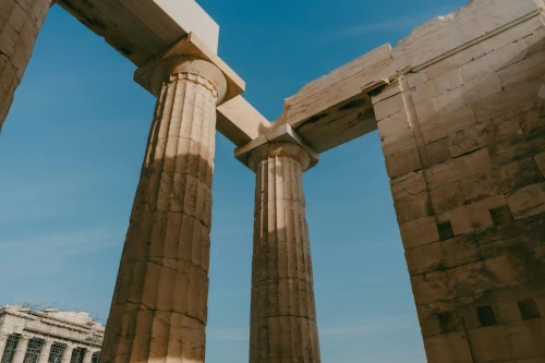 View of ancient Greek columns on a sunny day at the Acropolis of Athens
