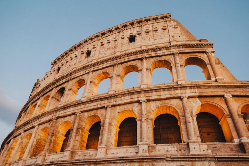 A stunning view of the Colosseum in Rome during sunset, showcasing ancient Roman architecture