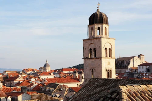Explore the iconic red rooftops and historic architecture of Dubrovnik, Croatia in this sunny cityscape