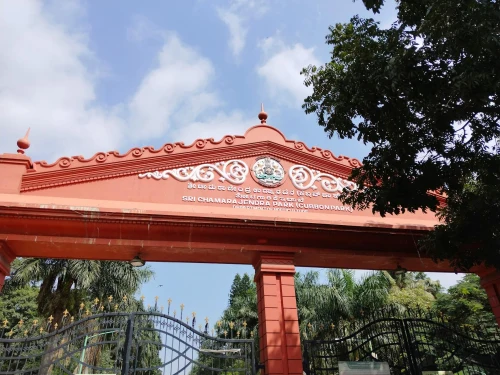 The iconic red entrance gate of Sri Chamarajendra Park in Bengaluru under a clear sky