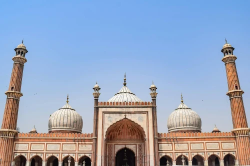 The iconic Jama Masjid mosque in Delhi with its impressive architecture against a blue sky
