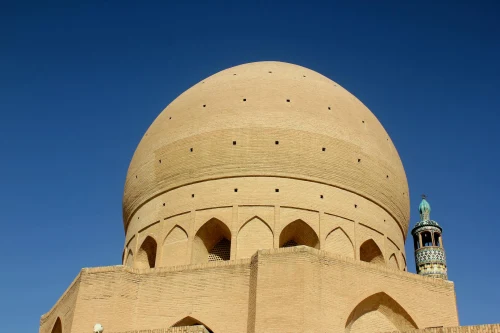 Beautiful view of the Jameh Mosque of Yazd with its distinctive dome architecture against a clear blue sky