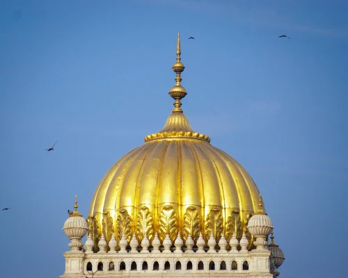 Stunning view of the golden dome of Mysuru Palace against a clear blue sky