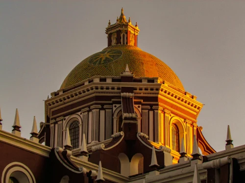 A stunning view of the Puebla Cathedral dome at sunset, showcasing beautiful architectural details